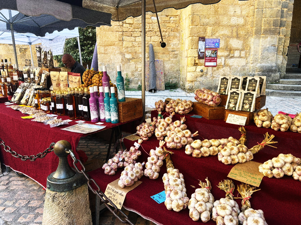 Garlic and oil stall in front of Sarlat cathedral